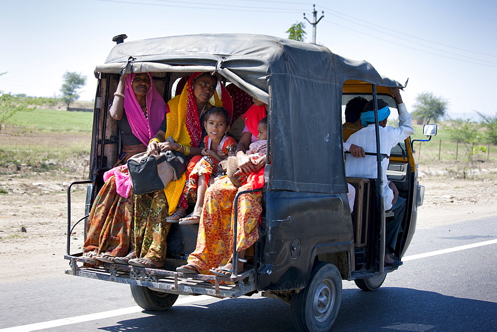 Family on the move on Delhi to Mumbai National Highway 8 at Jaipur, Rajasthan, Northern India