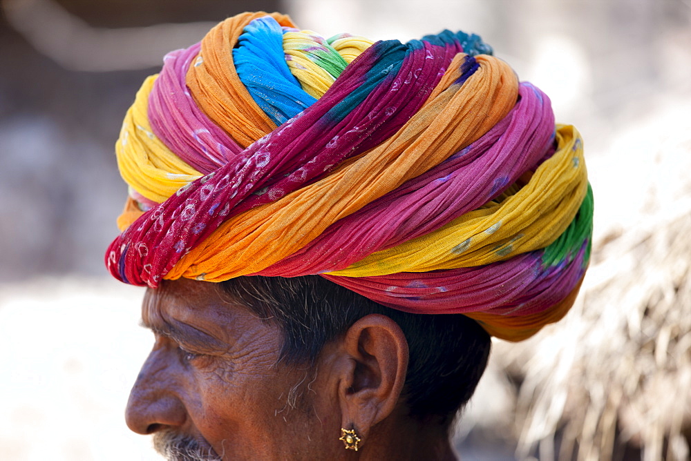 Indian man wearing traditional Rajasthani turban and gold earring in village of Nimaj, Rajasthan, Northern India