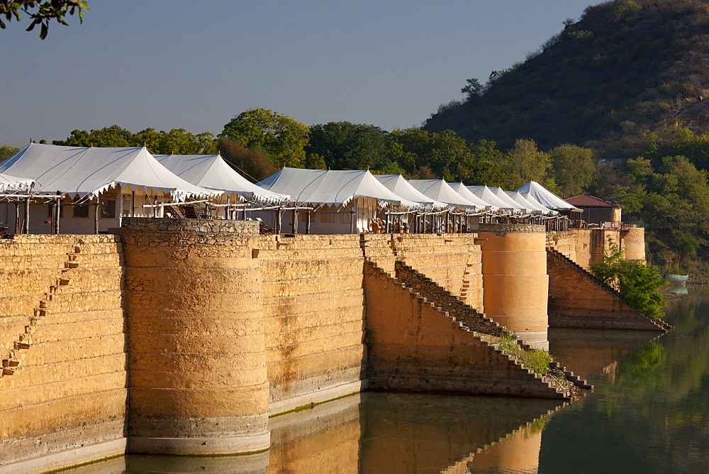 Chhatra Sagar reservoir and luxury tented camp oasis in the desert at Nimaj, Rajasthan, Northern India