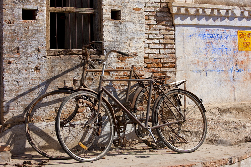 Bicycles propped on old building in Narlai village in Rajasthan, Northern India