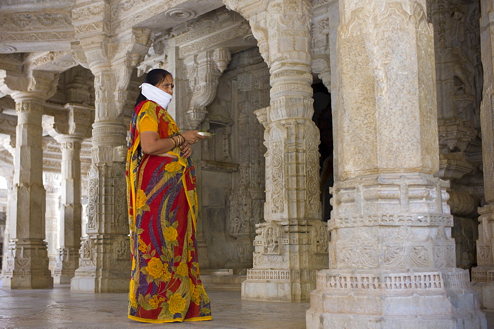 Jain pilgrim with traditional mask at The Ranakpur Jain Temple at Desuri Tehsil in Pali District, Rajasthan, India