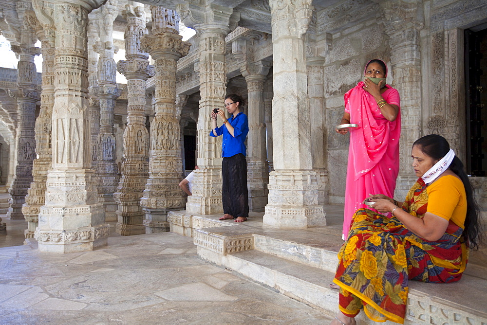 Jain pilgrims with traditional masks at The Ranakpur Jain Temple at Desuri Tehsil in Pali District, Rajasthan, India