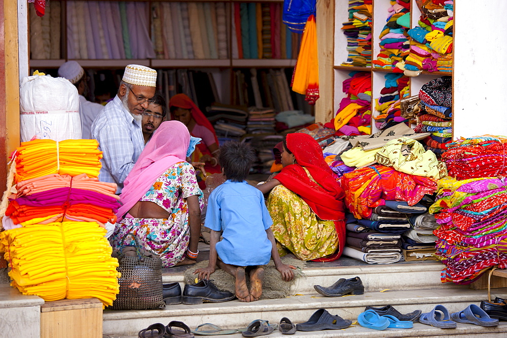 Indian family shopping for children's clothes in old town in Udaipur, Rajasthan, Western India, Hindus and Muslims together.