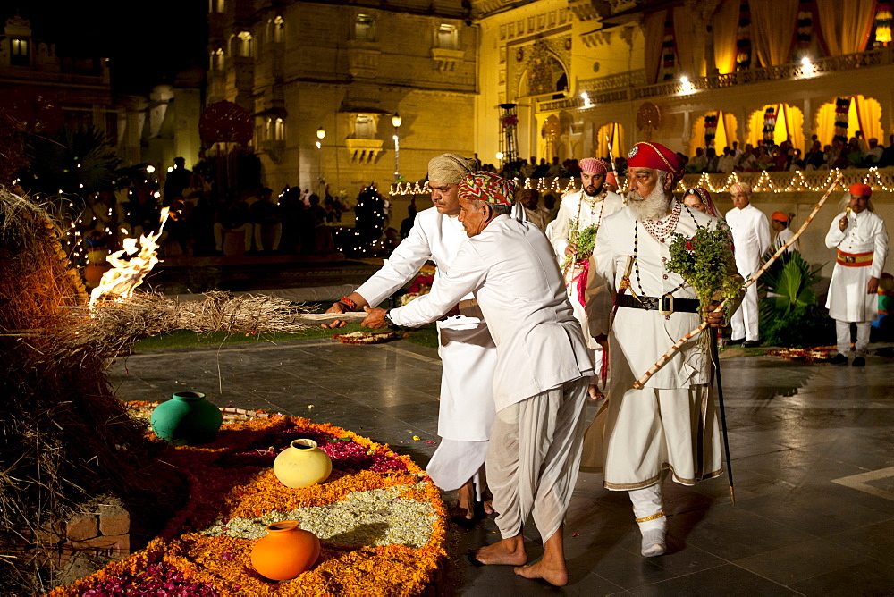 Shriji Arvind Singh Mewar of Udaipur, 76th Custodian of the House of Mewar, presides at annual Hindu Holi Fire Festival at The Zenana Mahal in the City Palace, Udaipur, Rajasthan, India. With him is son and heir Lakshyaraj Singh Mewar of Udaipur, Maharaj Kumar and Hindu priests