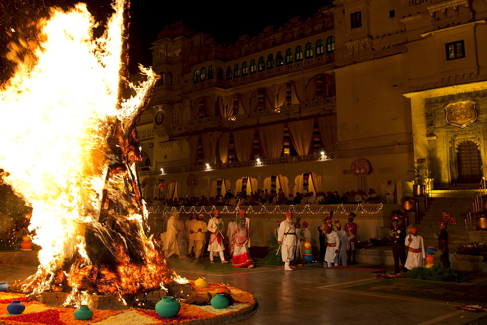 Shriji Arvind Singh Mewar of Udaipur, 76th Custodian of the House of Mewar, presides at annual Hindu Holi Fire Festival at The Zenana Mahal in the City Palace, Udaipur, Rajasthan, India. With him is wife  Maharani Vijaya Laxmi and son  and heir Lakshyaraj Singh Mewar of Udaipur, Maharaj Kumar