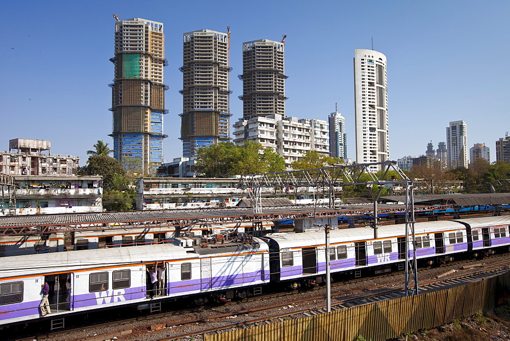 High rise developments by Mahalaxmi Station and the Western Railways train of the Mumbai Suburban Railway, India