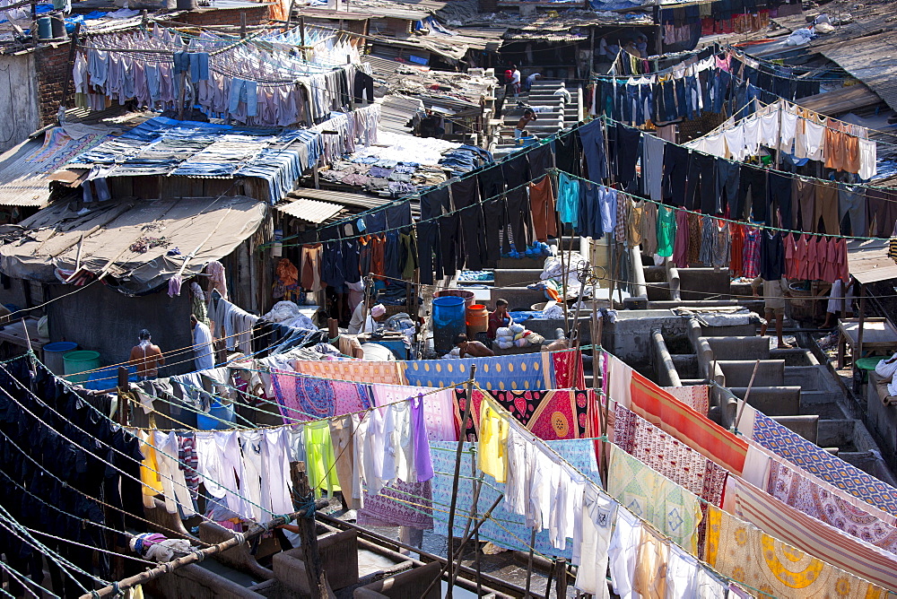 Indian hand laundry, Dhobi Ghat, and laundrymen with traditional flogging stones to wash clothing at Mahalaxmi, Mumbai, India