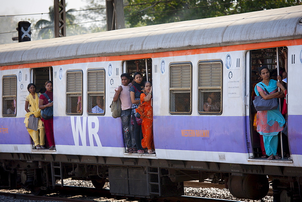 Female workers on crowded commuter train of Western Railway near Mahalaxmi Station on the Mumbai Suburban Railway, India