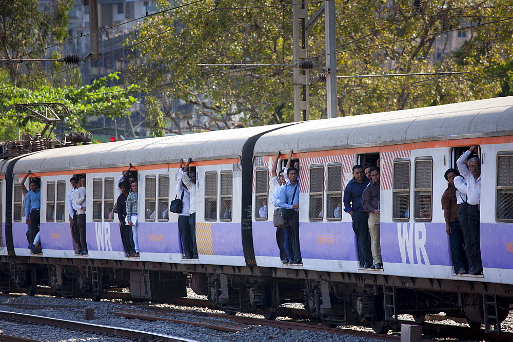 Office workers on crowded commuter train of Western Railway near Mahalaxmi Station on the Mumbai Suburban Railway, India