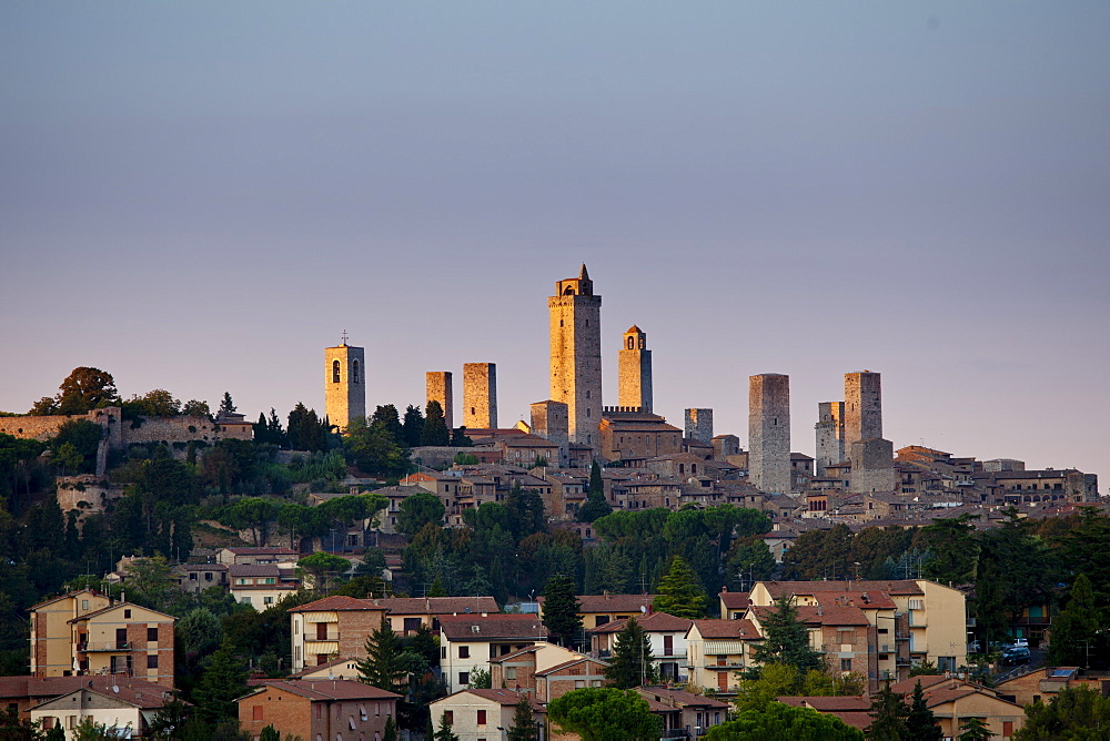 Contrast of contemporary and quaint medieval architecture of San Gimignano and its famous towers in Tuscany, Italy