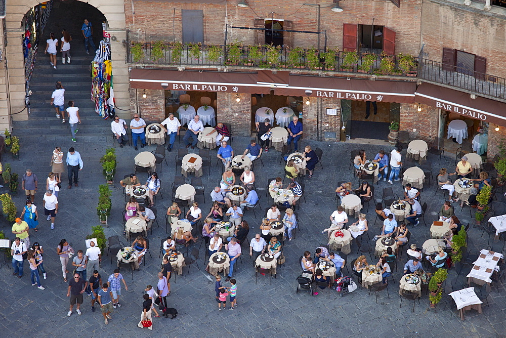 Aerial view from Il Torre, clock tower of diners at Bar Il Palio in Piazza del Campo, Siena, Italy