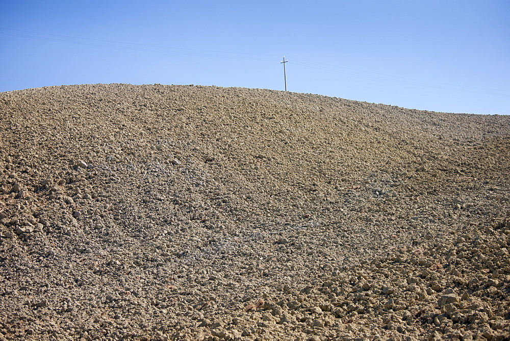 Telegraph pole in barren landscape at Murlo in Tuscany, Italy