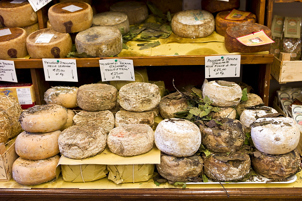 Italian artisan cheese shop, Del Bottega Naturista in Corso Rossellino including Pecorino Stagionato aged cheese in Pienza, Tuscany, Italy