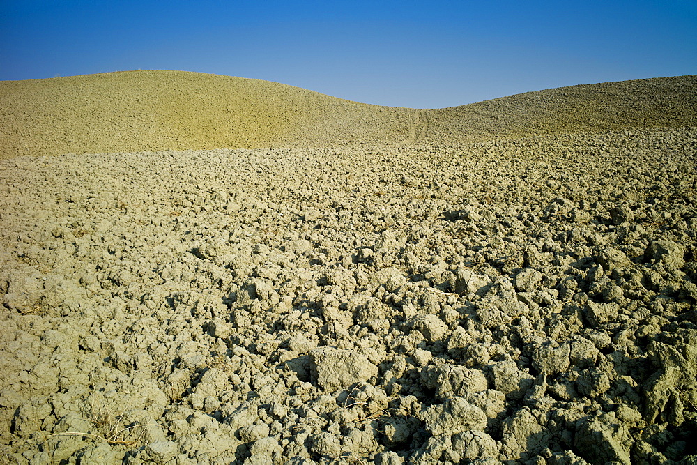 Tuscan parched landscape sun-baked soil  in Val D'Orcia, Tuscany, Italy