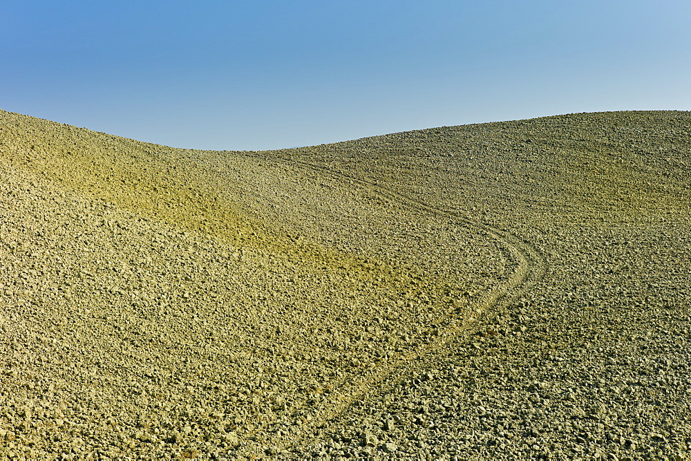 Tuscan parched landscape sun-baked soil  in Val D'Orcia, Tuscany, Italy