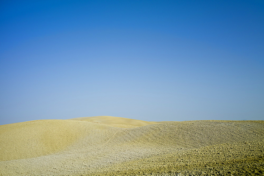 Tuscan parched landscape sun-baked soil  in Val D'Orcia, Tuscany, Italy