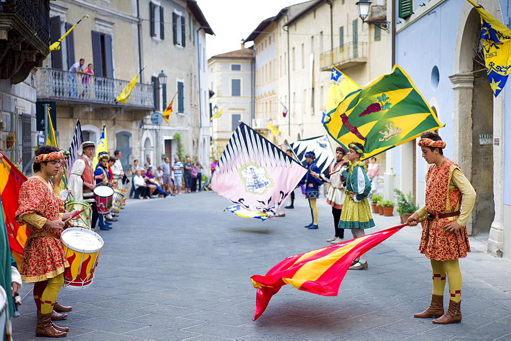 Contrada young man in livery costumes at traditional parade in Asciano, inTuscany, Italy