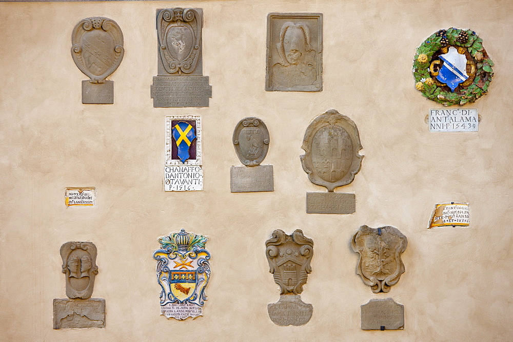 Badge crests on the Town Hall, The Palace of the Podestra, in Piazza Francesco Ferrucci, Radda-in-Chianti, Tuscany, Italy