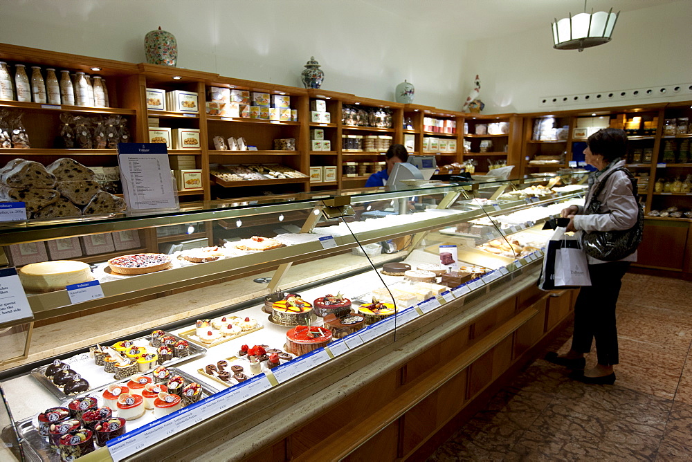 Shop display of artisan pastries and cakes at Dalmayr food shop and delicatessen in Munich, Bavaria, Germany