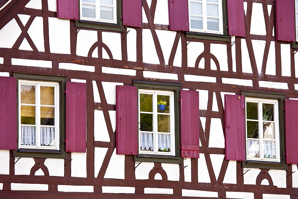 Windows and wooden shutters of quaint timber-framed house in Schiltach in the Bavarian Alps, Germany