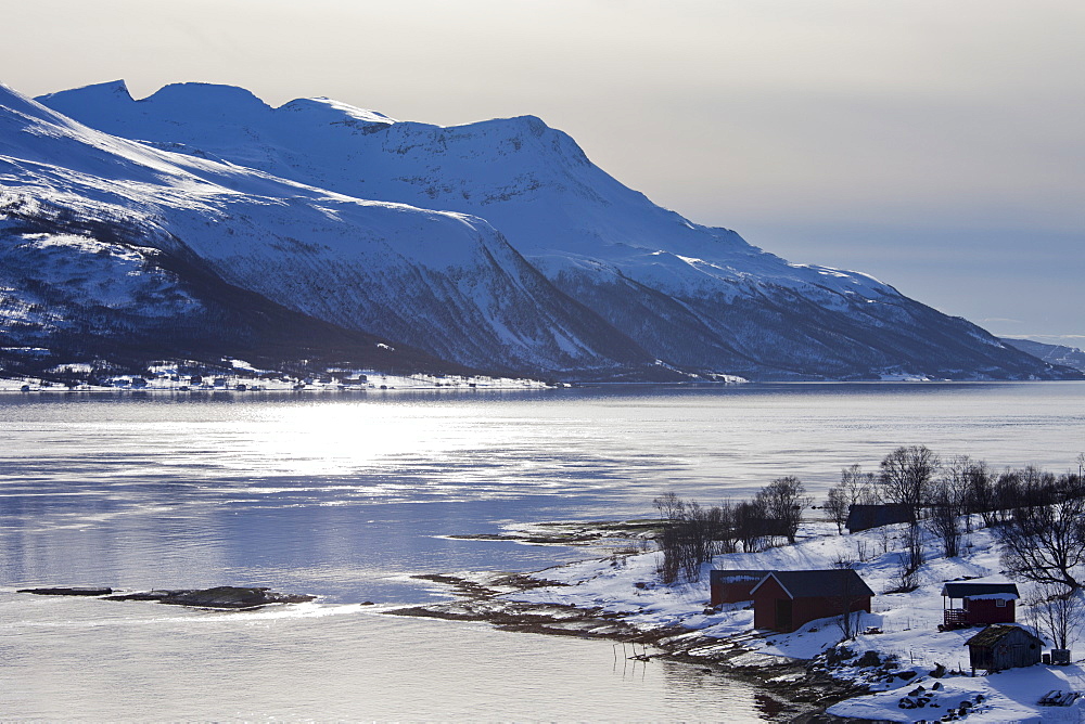 View across Tromso Sound to Tromso and the Lyngen Alps from Kvaloya Island in Arctic Circle Northern Norway