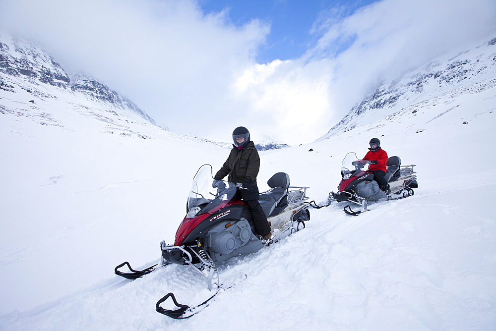 Snowmobiling in the arctic alps in the Arctic Circle near Holt in the region of Tromso, Northern Norway