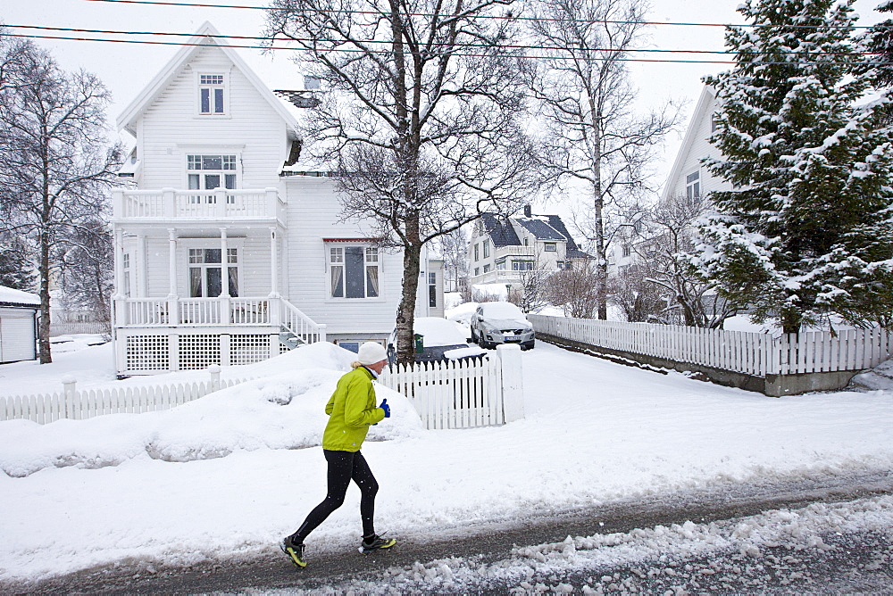 Local woman jogging in Jonas Lies Gate, the elegant  residential area of Tromso within the Arctic Circle in Northern Norway