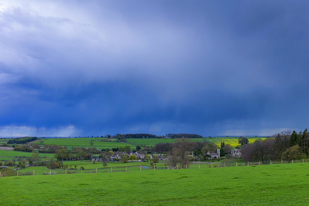 Rainstorm from Cumulonimbus cloud above Asthall Village in springtime in the Cotswolds, Oxfordshire, UK