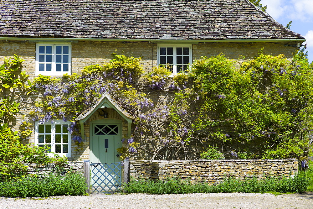 Traditional Cotswold stone wysteria-clad cottage in the quaint village of Eastleach Turville in the Cotswolds, Gloucestershire, UK