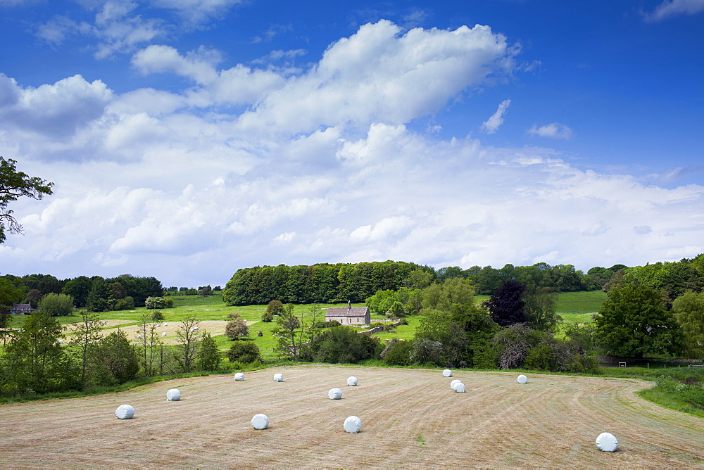 English countryside with chapel in a field, St Oswald's, in The Cotswolds, Oxfordshire