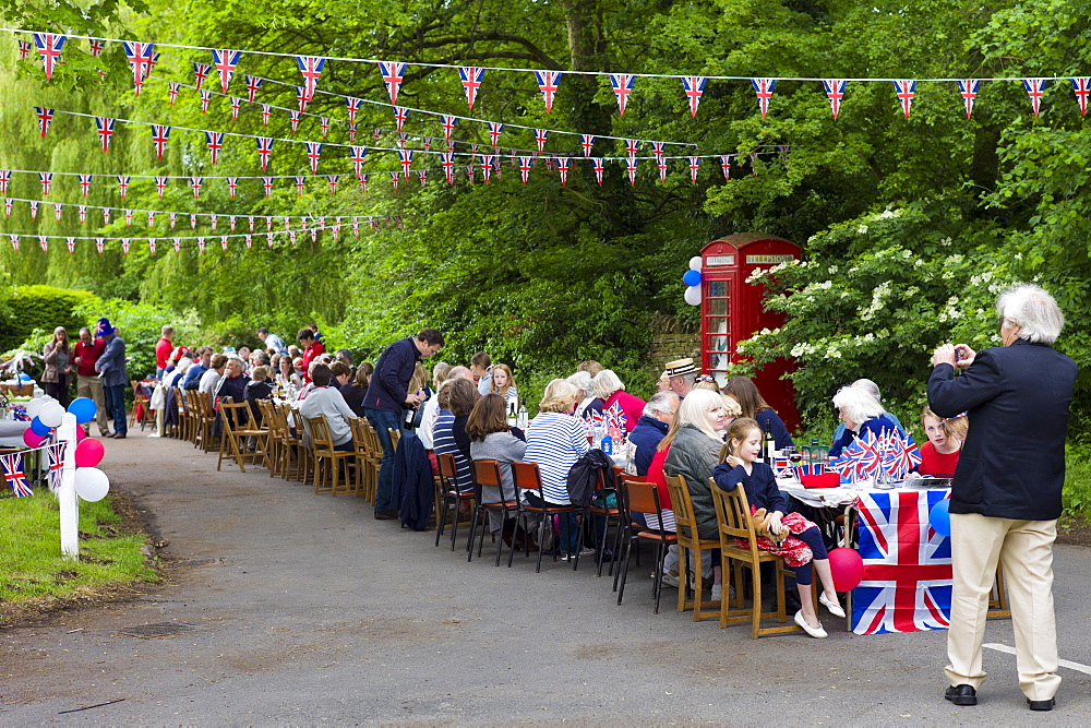 Street party with Union Jack flags and bunting to celebrate Queen's Diamond Jubilee at Swinbrook in The Cotswolds, UK