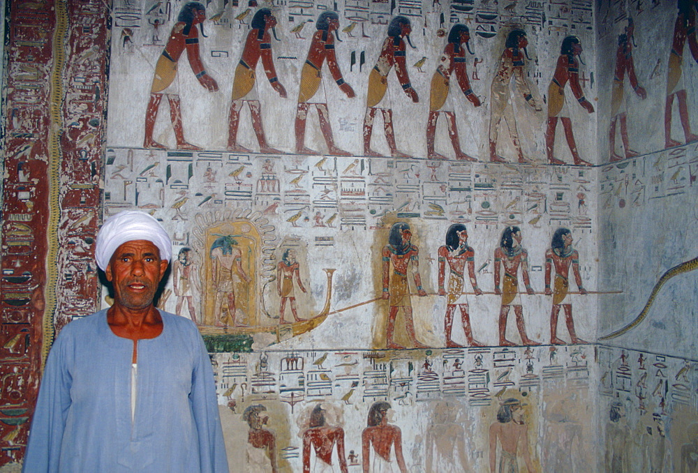 Egyptian man standing guard in King Seti's tomb in the Valley of the Kings, Luxor, Egypt