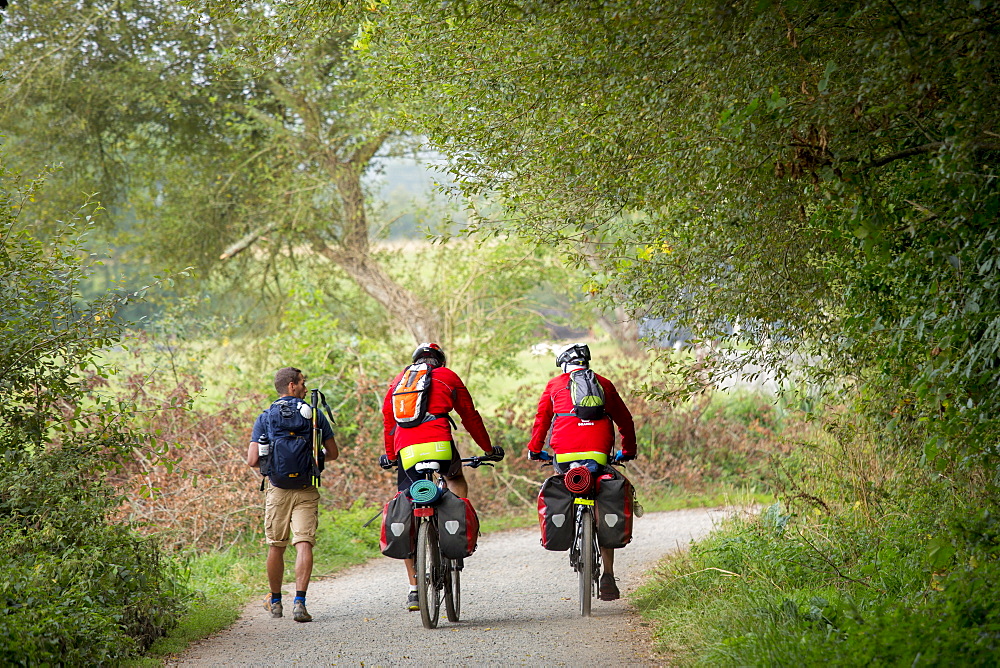 Cyclists and walker on the Camino de Santiago Pilgrim's route to Santiago de Compostela in Galicia, Spain