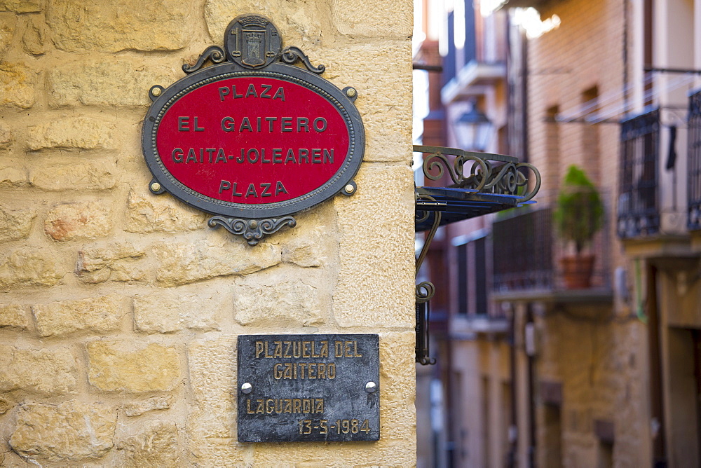 Street signs in Spanish and Euskera Basque language in central square of Basque town of Laguardia in Rioja-Alavesa area of Spain