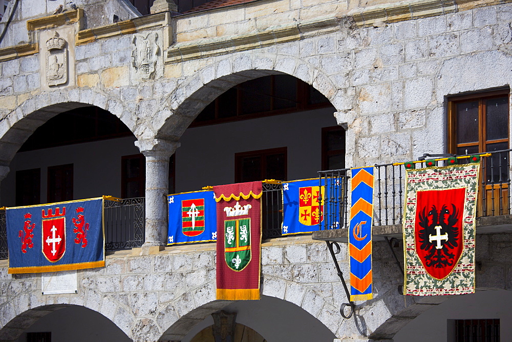 Spanish banners at medieval building in Plaza de la Constitucion 19 March 1812 in Laredo, Cantabria, Spain