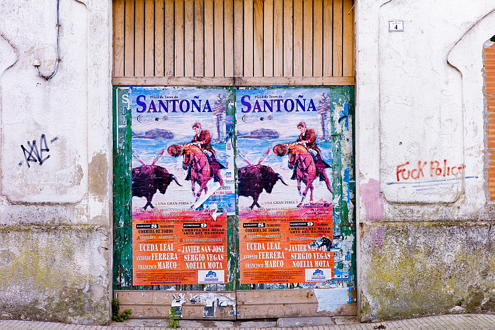 Plaza de Toros de Santona bullfight poster and anti-police abusive slogan in Cantabria, Northern Spain