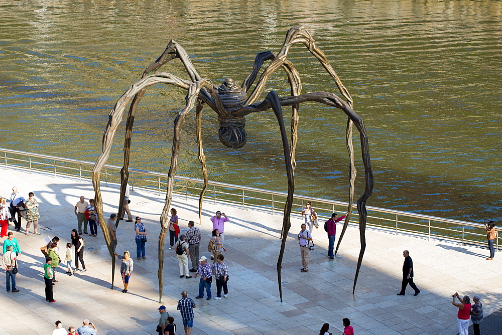 Spider bronze sculpture 'Maman' by Louise Bourgeois and tourists at Guggenheim Museum in Bilbao, Basque country, Spain