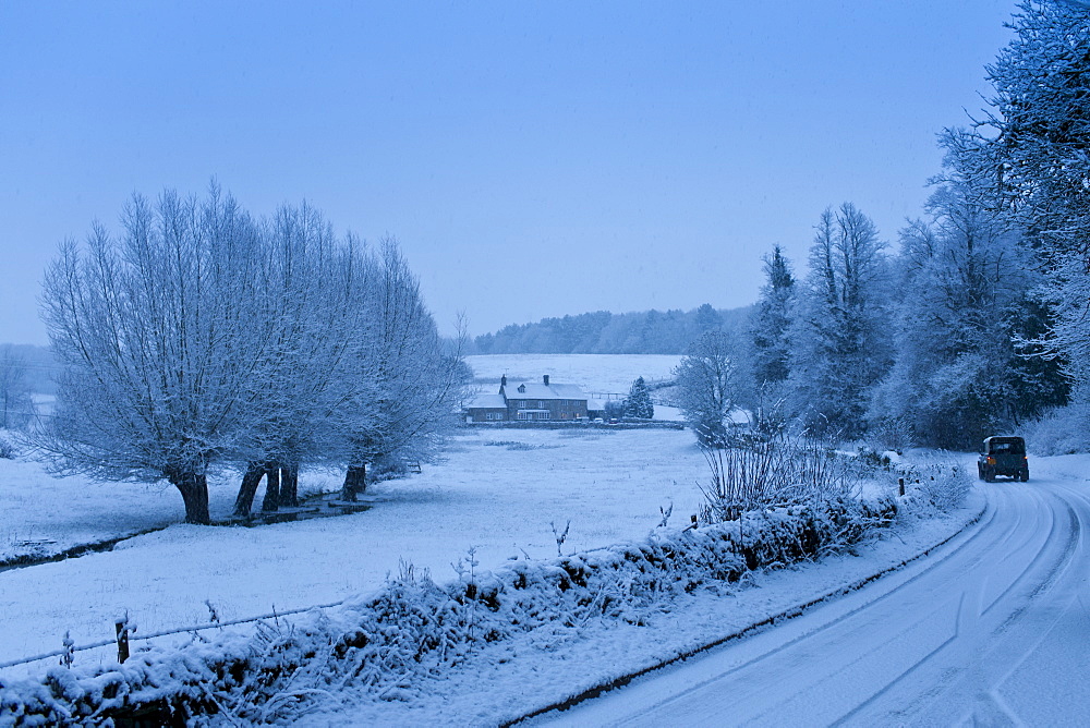 Traditional snow scene in a typical Cotswolds village, Swinbrook, Oxfordshire, United Kingdom