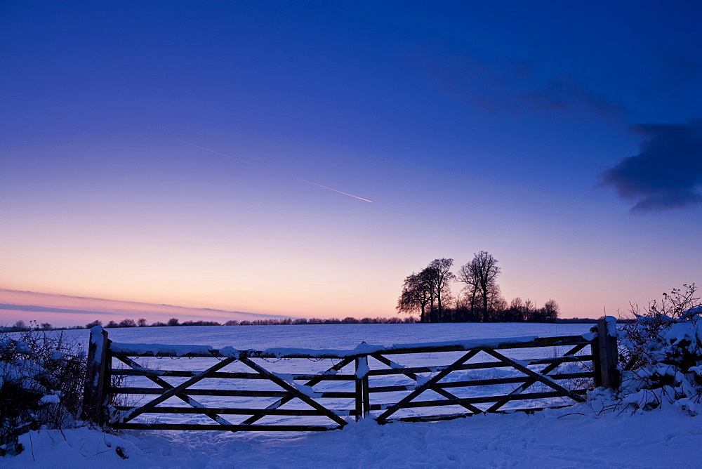 Farm gate in traditional snow scene in The Cotswolds, Swinbrook, Oxfordshire, United Kingdom