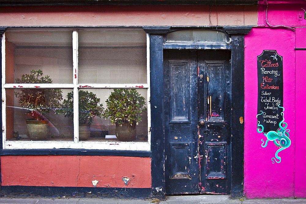 Faded elegance of a salon offering tattoo, piercing, body jewellery in Youghal, County Cork, Southern Ireland