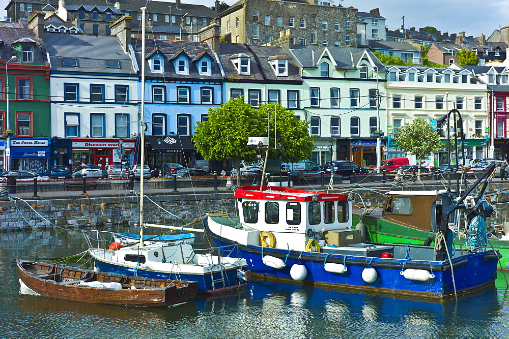 Popular as a tourist destination Cobh harbour with brightly coloured fishing boats in County Cork, Ireland