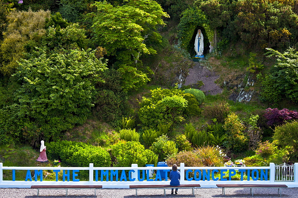 Pilgrim at Grotto of the Virgin Mary and The Immaculate Conception at Ballinspittle near Kinsale, County Cork, Ireland