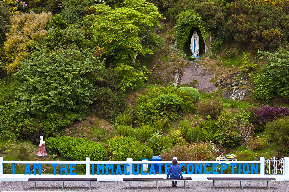 Pilgrim at Grotto of the Virgin Mary and The Immaculate Conception at Ballinspittle near Kinsale, County Cork, Ireland