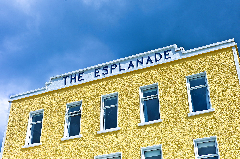 Brightly coloured Esplanade Hotel on the seafront at Kilkee popular beach resort, County Clare, West Coast of Ireland