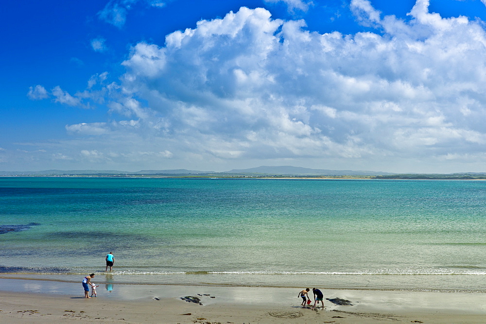 Family fun at the sandy beach on the west coast near Doonbeg, County Clare, West Coast of Ireland