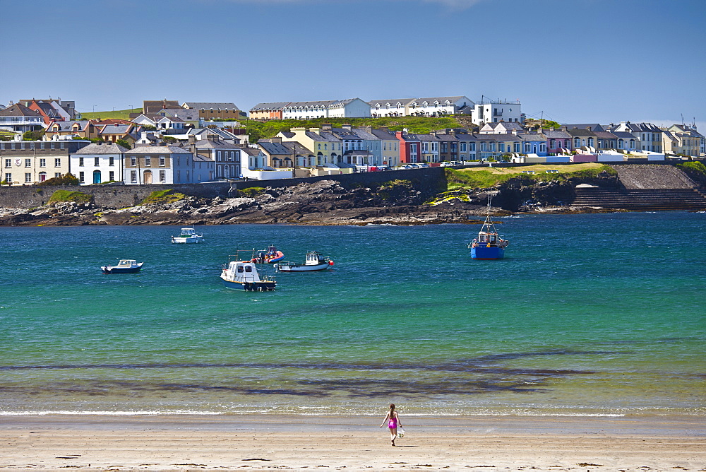 Ocean front houses and child playing on sandy beach at Kilkee  County Clare, West Coast of Ireland