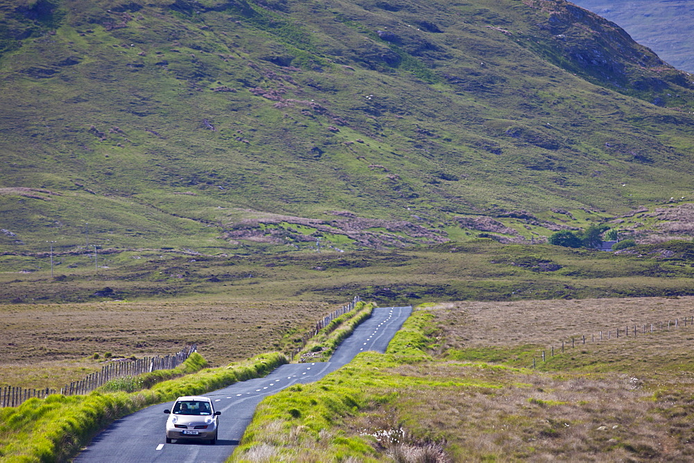 Tourist on Kylemore Pass by the Twelve Bens mountains, Connemara, County Galway, Ireland