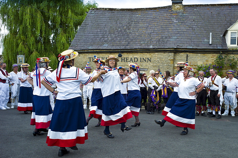 England's Glory Ladies Morris dancers perform a dancing display at The Kings Head Pub in Bledington, Oxfordshire, UK