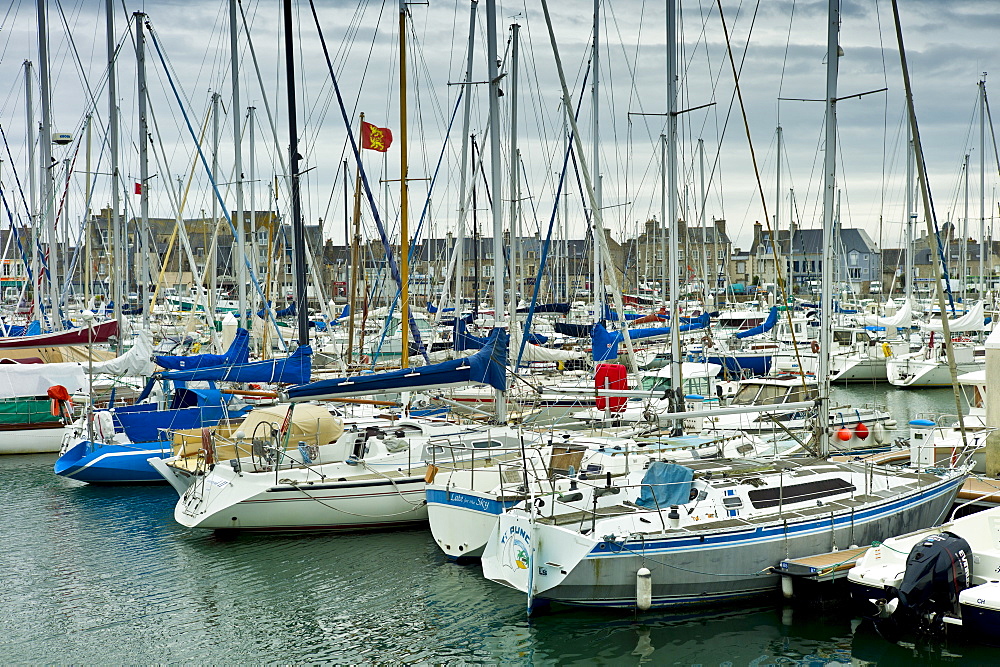 Yachts and power boats moored in the Marina at St Vaast la Hougue channel port in Normandy, France