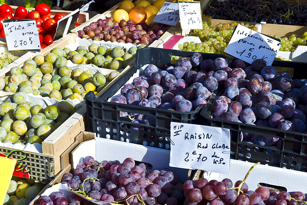 Plums, grapes and greengages fresh fruit on sale at food market at La Reole in Bordeaux region of France